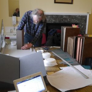 Measuring a row of books for creating shelf liner 