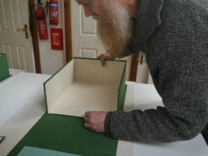 Covering box trays in green cloth