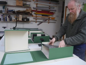 Covering box trays in green cloth