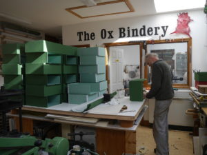 Covering box trays in green cloth