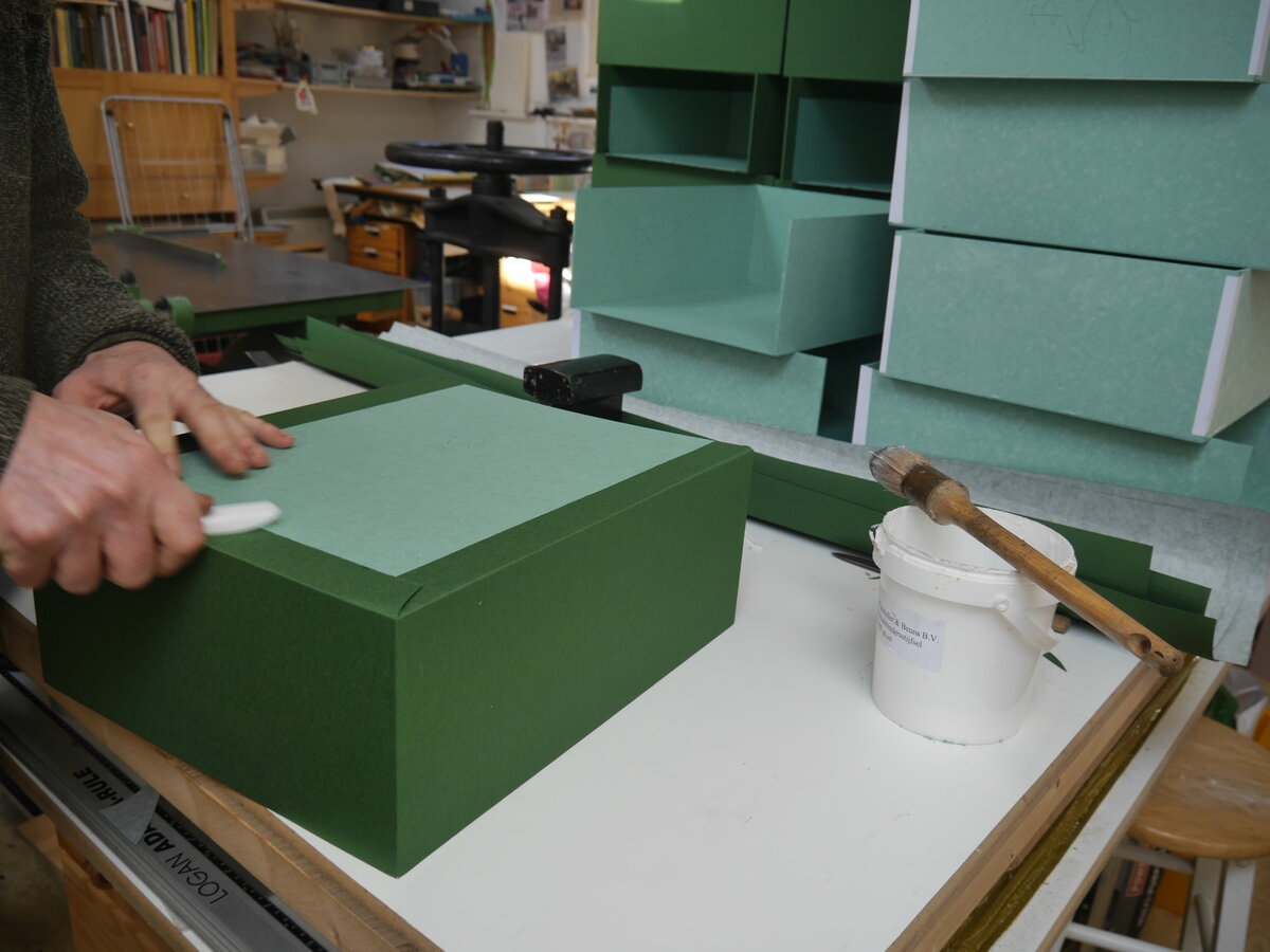 Covering box trays in green cloth